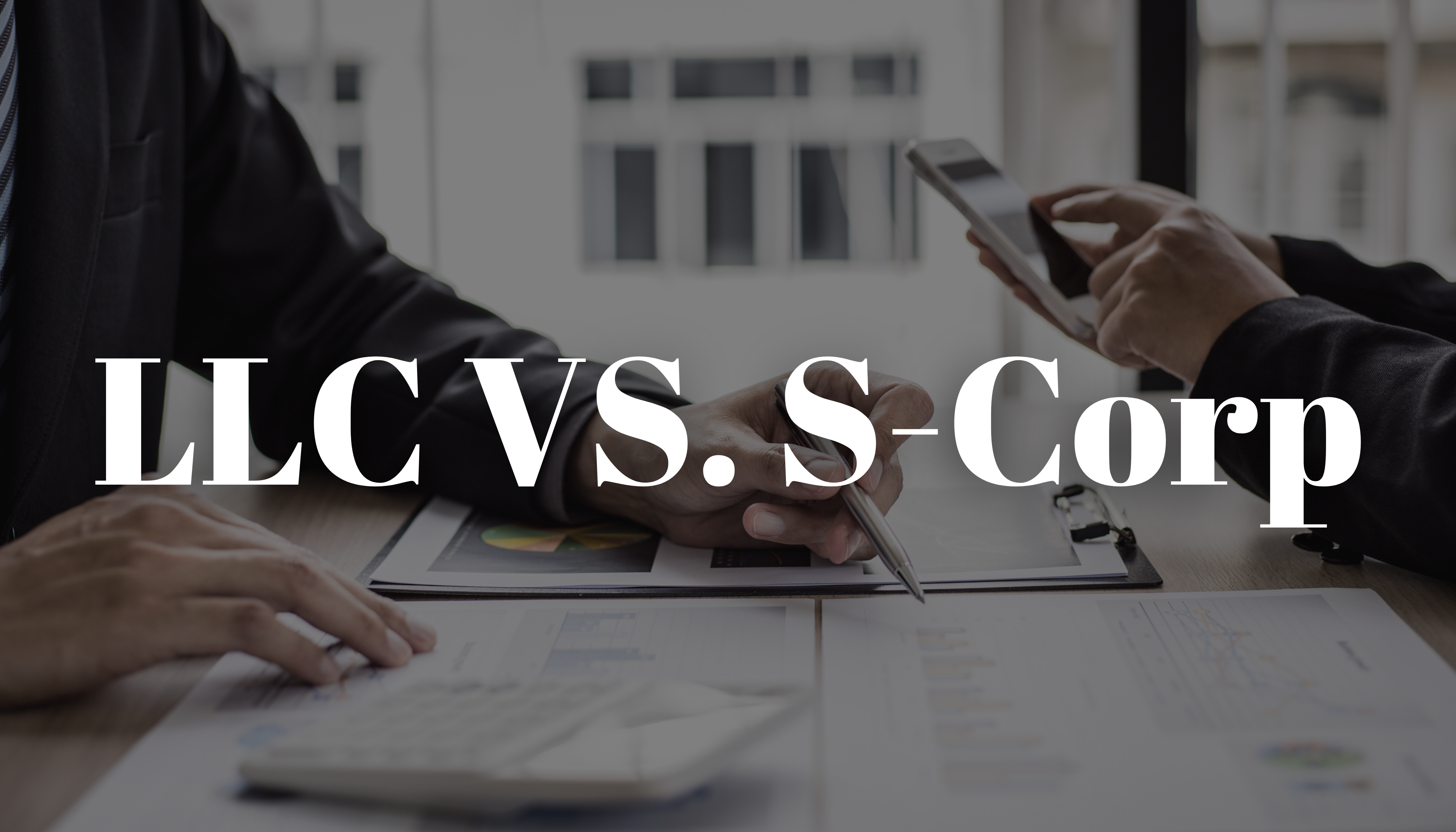 Difference Between LLC and S Corp: Two individuals going over business documents