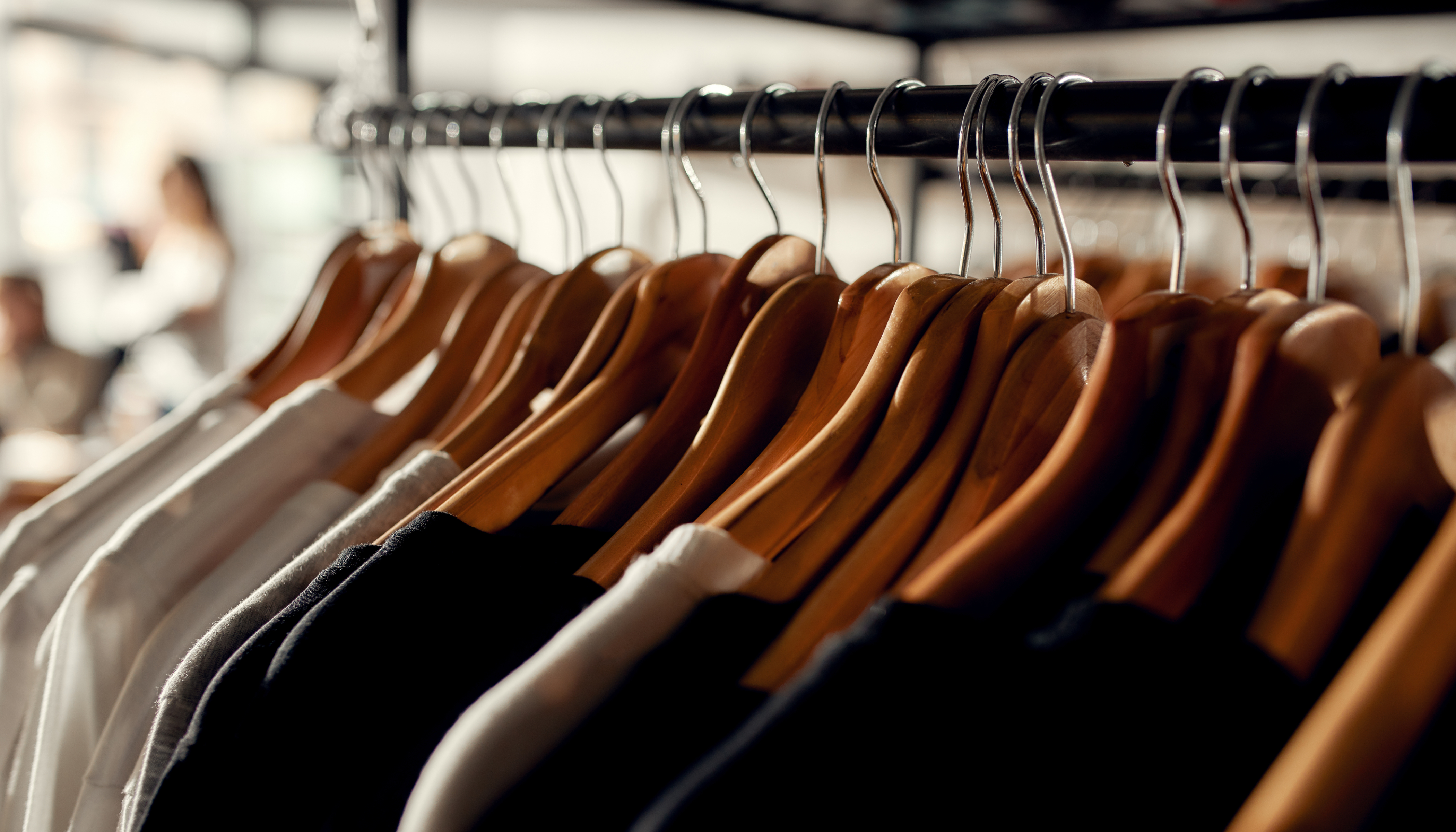 How to Start a Clothing Brand: Image showcasing t-shirts hanging in a store.