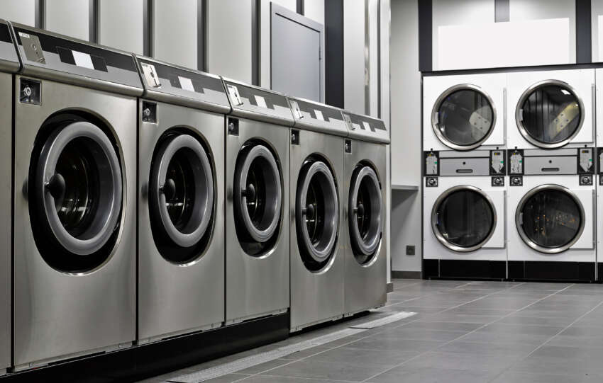Laundromat Business Name Ideas: A row of industrial washing machines in a public laundromat