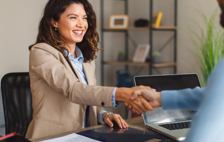 What Is a Business Operating Agreement?: An image of a smiling businesswoman shaking a man's hand.